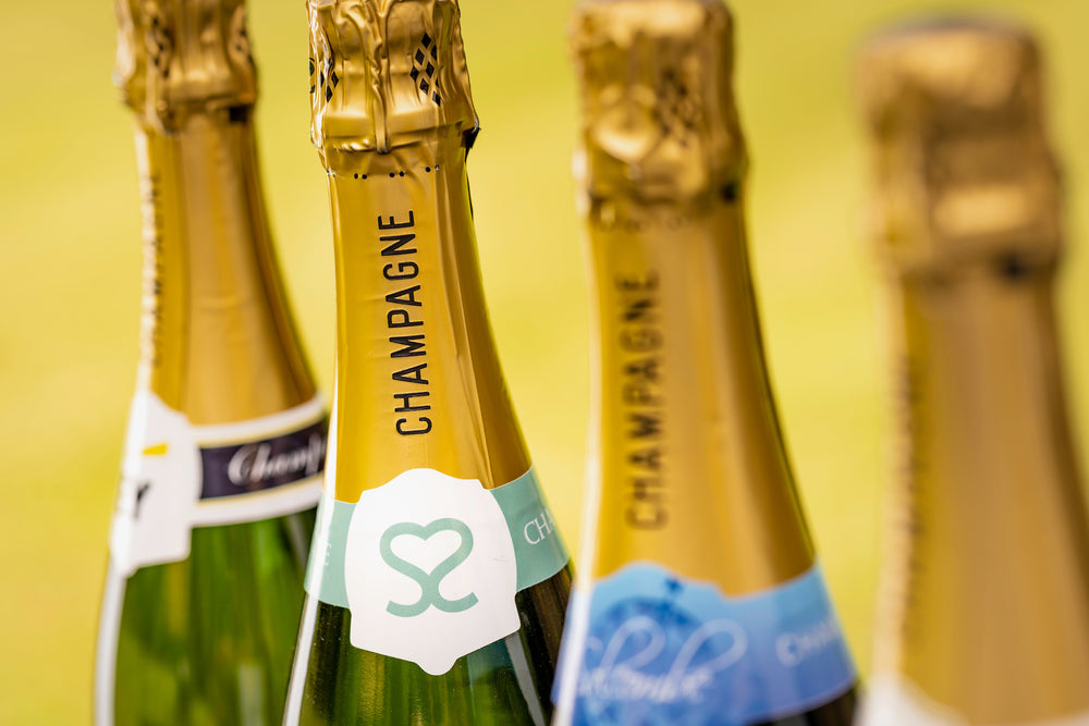 Close up of 4 bottles of branded champagne