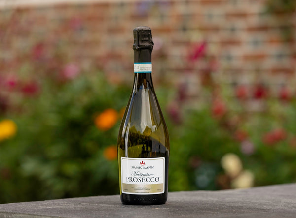 Personalised bottle of Prosecco on bench by Park Lane Champagne